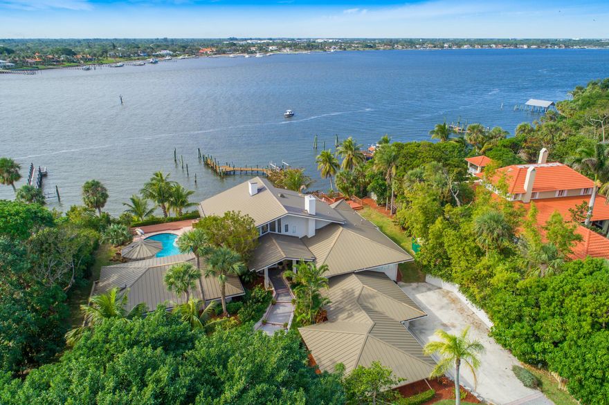 Rare find in sought after Sewall's Point, FL. Gated, Waterfront Luxury Estate on 1.5 acres with 158’ of water frontage. California contemporary meets Coastal Florida Luxury! Deep water dockage with new dock in 2016. Bring your mega yacht! Extensive remodel with over $1 million in upgrades. Sitting 50’ foot on the bluff, you have endless water views and spectacular sunsets. Whole house generator, plus 600 bottle chilled wine room in game room. This home offers 2 offices, guest suite, & a theatre room. Master suite on the first floor, with his & her closets, master bath has been remodeled as well. Enjoy the open & airy living area with panoramic water views from all directions! New kitchen in 2016. Of course, it gets the #kimspearsapproved on the classic white, custom cabinetry. Too many upgrades to list, but truly one of a kind!