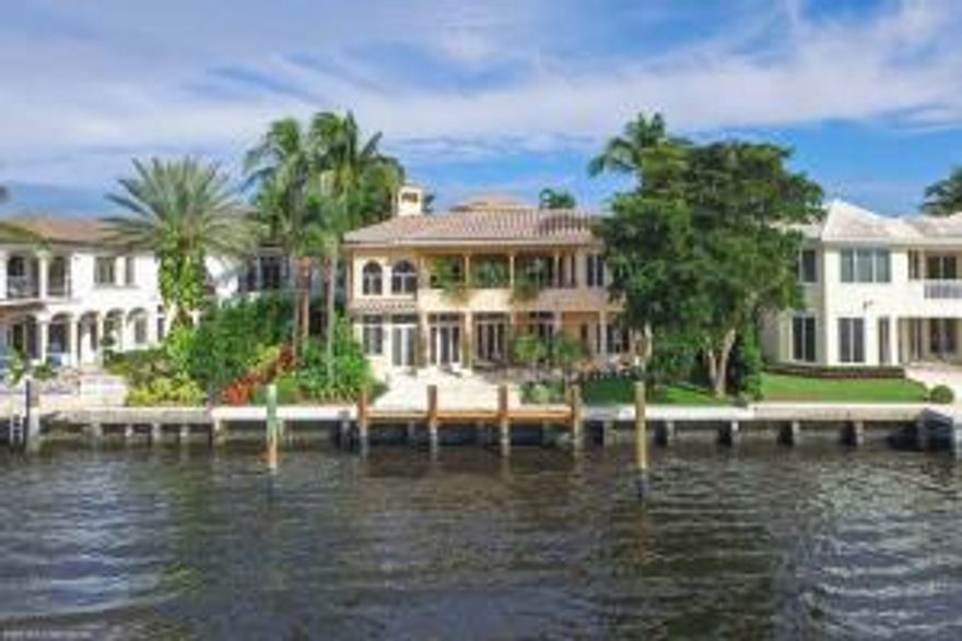 This direct Intracoastal Waterway Estate is located in Highland Beach with 80 feet of direct waterfrontage. Highland Beach is a private Coastal Community just south of Delray and north of Boca Raton with shopping and dining just minutes away. Complete with pool, dock and private beach access, this contemporary Mediterranean residence enjoys an open floor plan and natural light showcasing the spectacular water views throughout. The private, walled compound has a gated entrance and decorative driveway that lead to the courtyard entrance with a scenic view of the tropical and well-established landscape and front wall fountain. The courtyard provides the first introduction to the tranquil pool area inviting hours of relaxation or entertaining with the spacious pool, spa and covered loggia with living and dining area. The arched double door entryway opens to unveil the exceptional interior and foyer with soaring ceilings, marble floors, views of the pool and a color palette that complements every stunning detail. The grand curved staircase sets the stage for the grand salon with fireplace, wet bar, volume ceilings, marble floors and windows galore bathing the room in natural light further enhancing the clean lines of this contemporary space. The elegant living room is picture perfect with custom mill-work and glass doors and windows. The formal dining room features tray ceiling and views of the pool with wine closet nearby to complete the epicurean experience. The kitchen is bright and open with sleek countertops, clean white cabinets with an abundance of space, island with sink and new appliances including gas range, double oven, wine cooler and dishwasher. The kitchen flows effortlessly to the breakfast area and family room with endless water views and glass doors that lead to the waterfront covered loggia and dock. The second floor master suite is a private retreat bathed in soft, natural light and framed by endless water views. Complete with sitting area, private covered balcony, his-and-her walk-in closets and a luxurious master bath with endless vanity countertops, mirrors, Jacuzzi tub and a central island double-sided glass shower with dual entrances. The second story office enjoys views of the Intracoastal as well as the gorgeous grand staircase and first floor living areas. The media room sets the tone for hours of enjoyment with walnut paneling and built-in entertainment center. Four spacious guest bedrooms provide ample space and privacy for residents and guests alike. The tiled roof-top deck provides breathtaking, long water views and is easily accessed by the spiral staircase or the hydraulic elevator that serves the home's three levels. Outdoor living and entertaining is a breeze with two separate covered loggias; one poolside and the other waterside. The large pool and covered spa are framed with lush landscape, a fountain and column archways that open to the covered loggia with living and dining area. For convenience there is a cabana bath, outdoor shower and several access points to the interior from the pool and loggia. The second loggia and open terrace are accessed via the family room and provide endless water views. Boating is a delight with 80 feet of direct Intracoastal waterfrontage with private dock and easy ocean access via the Boca Raton inlet nearby. The property enjoys private beach access across the street through a membership in the voluntary homeowner's association. The residence also features a three-car garage, Bang & Olufsen stereo throughout, natural gas, full shutters, crown molding, volume ceilings, marble and wood floors, clerestory windows and a plethora of French doors. Recent improvements include newer air-conditioning units throughout, new gas range, new dishwasher, new wine storage, new double oven, updated security system, new marcite pool finish, new compressor in wine closet, new refrigerator with ice maker in wet bar and refinished staircase. Bathed in natural light and designed to perfection, this contemporary direct Intracoastal estate is a masterpiece to behold. Situated in on a prime Intracoastal lot with 80 feet of direct waterfrontage, the location is second to none.