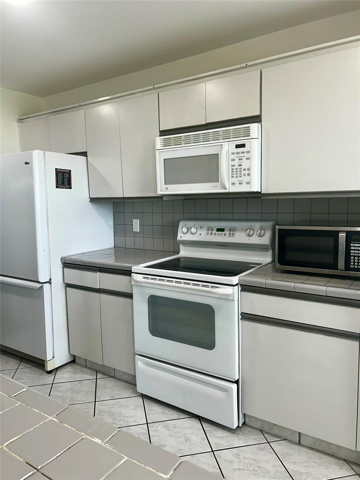 Welcome to this beautifully maintained Evergreen model, nestled in a highly desirable 55+ community. This spacious and light-filled 4th-floor unit offers comfort, convenience, and an ideal location. Thoughtfully designed with an open layout, this property features an in-unit washer and dryer, generous living space, and has been kept in pristine condition. The inviting primary bedroom is a true retreat, complete with a walk-in closet, en suite bathroom, and direct access to a charming enclosed patio perfect for enjoying your morning coffee or unwinding in the evening. Located just a short stroll from the community pool and mere steps from the fitness center and theater, this home offers easy access to the very best in active adult living. One occupant must be at least 55 years of age.