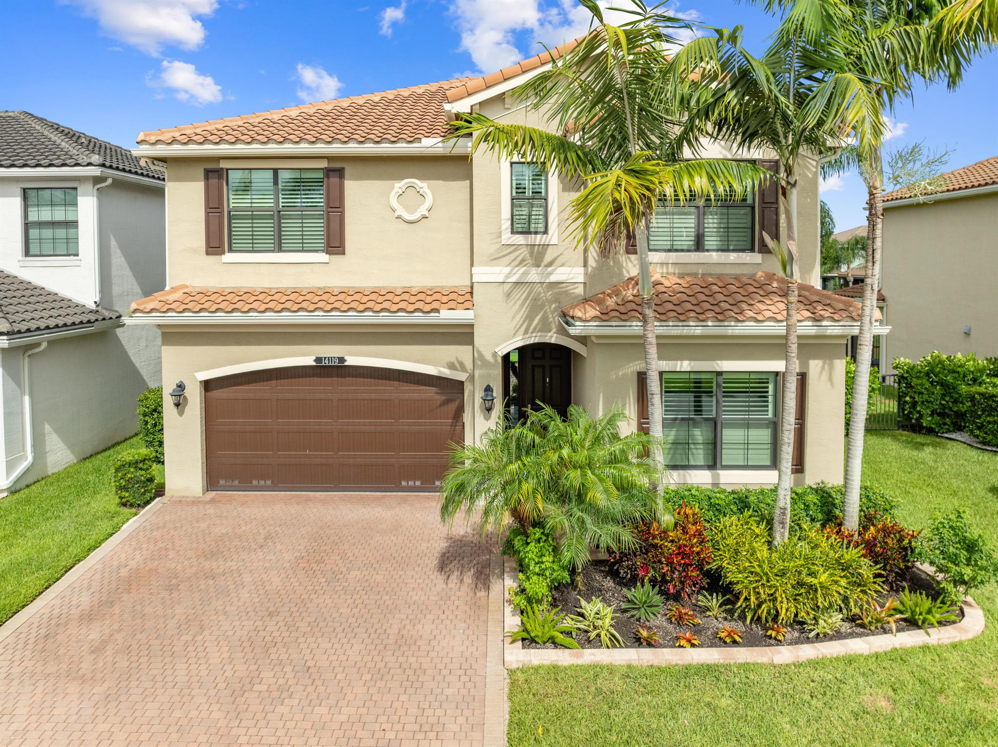 Welcome to this beautifully maintained, move-in ready two-story home, ideally situated on a premium lot with scenic water views in one of South Florida's most desirable gated communities. This 24/7 guard-gated neighborhood offers the perfect blend of resort-style living and everyday comfort.Step inside and experience timeless elegance paired with functional design. Wide-plank luxury vinyl flooring flows seamlessly through the main living areas and bedrooms, complemented by crown molding throughout. Plantation shutters provide privacy and style on the hurricane-impact windows, while custom drapery accents the sliding glass doors that open to an extended brick-paver patio--perfect for relaxing or entertaining. An extended brick-paver driveway adds both curb appeal and convenience.