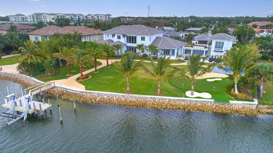 Fantastic new Intracoastal estate with an expansive backyard and 160' of frontage overlooking the Juno Beach Preserve. Within walking distance to the Beach and East exposure, this custom residence has 5 bedrooms in the main house and a completely separate guest house with one bedroom, a kitchenette, laundry and a one car garage. The main residence boasts a Chef's kitchen with top of the line Thermador appliances, leathered marble tops and back splashes, two dishwashers, gas oven/cooktop and a butler's pantry. The large master bedroom has his and her walk-in closets, and expansive bathroom with separate water closets and an adjacent laundry room. The covered loggia has electric screens and a complete summer kitchen with a Lynx gas BBQ, ice maker and two refrigerators.