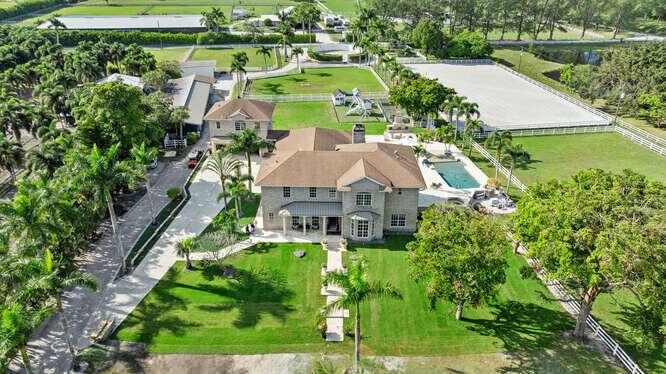 Discover luxury and privacy at this stunning 6-bedroom, 5-bathroom equestrian estate on 5 serene acres in West Boca Raton. Perfect for seasonal renters, this newly renovated Palm Beach-style home features marble and hardwood floors, a gourmet kitchen with a massive center island, and a lavish master suite with a marble fireplace, spa-like bathroom, and custom walk-in closets. The outdoor space boasts a resort-style pool with jacuzzi, a spacious patio with a paradise grill, a children's playground, and a mini putt-putt course. 14-stall barn with new stainless steel fronts, an outdoor, covered riding arena & grass field , 7 grassy paddocks, and a round pen.Grooms quarters avail! Conveniently located just 25-30 minutes from Wellington & Beach, and near top dining and shopping!