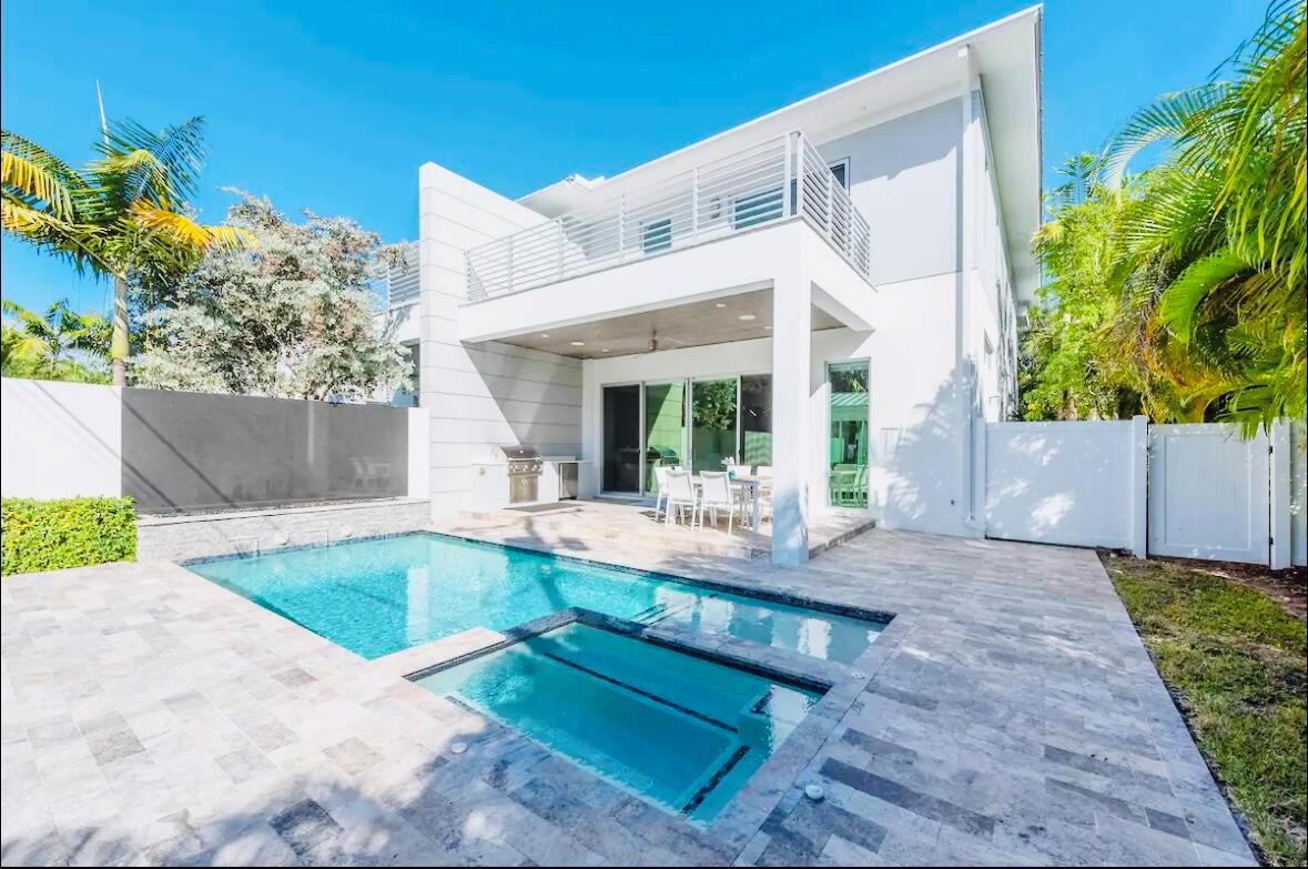 Live the Delray Beach lifestyle in your fully furnished villa built by Marc Julien, less than a mile from the beach and Atlantic Ave, steps away from PopStroke. This modern coastal home features high-end finishes throughout, including an industrial gas kitchen with Thermador appliances, smart home features with sound, lighting and electric blinds. Office space with glass pocket doors. Master features two extra large walk-in closets a luxurious bathroom and private balcony. All ensuite bedrooms with custom closets. The outdoor space offers a private tropical paradise perfect for entertaining under the lanai with summer kitchen, pool with heated spa, fire-pit space, plush covered lounge area and spacious guest house with full bath and complete outdoor shower. Home is listed on Airbnb/VRBO