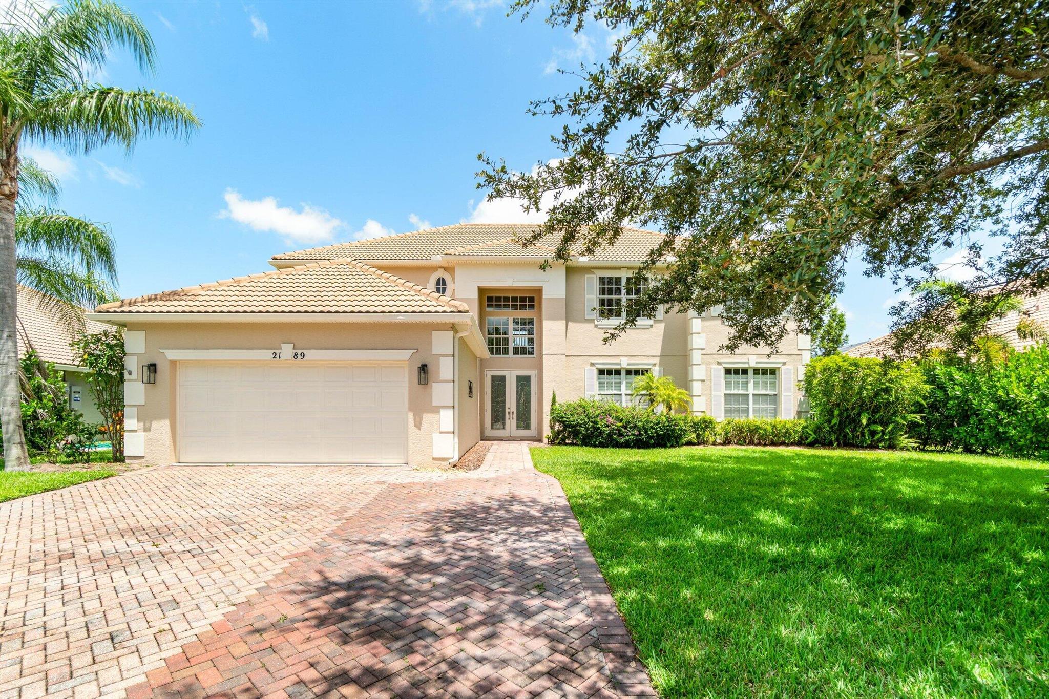 Experience Mediterranean elegance in the gated community of Lake Tuscany. This freshly painted 6-bedroom, 4.5-bath 2-story home features soaring ceilings, a spacious open-concept layout, and a chef's kitchen with granite counters, bar seating, and a large walk-in pantry. Enjoy peace of mind with hurricane-impact windows and doors . Dual staircases lead to a flexible upstairs layout, including a dual master suite with its own living area, office, full bath, and balcony--perfect for an in-law suite or guest retreat. Serene lake views, lush landscaping, and quick access to I-95 make this the perfect blend of comfort and convenience.