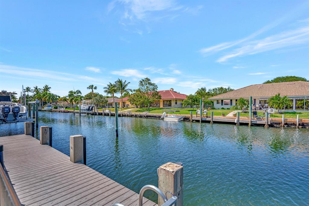 House on deep water in new condition, Renovated 2022, enlarged 2022. New metal roof 2022, New A/C 2023, New Granite in Kitchen and full baths 2022, Added full Cabana bath 2022, All new impact windows & doors 2022. Custom wood cabinetry in kitchen & full bath,, Natural polished stone floor zero grout lines throughout entire house, High vaulted ceilings, High end Kitchen appliances, New Pool Heater 2022, Large deck level with New composite boat dock 2021, New 16,000 lb boat lift 2021, Newly dredged to 5' at low tide 2023, space for 55' boat in addition to 35' on lift or larger if lift removed, new porcelain tile in air conditioned Garage 2022, Stainless Sink in Garage 2022 and sub zero refrigerator, New plumbing 2022 in kitchen and all full baths. New Exterior Stucco and paint 2022
