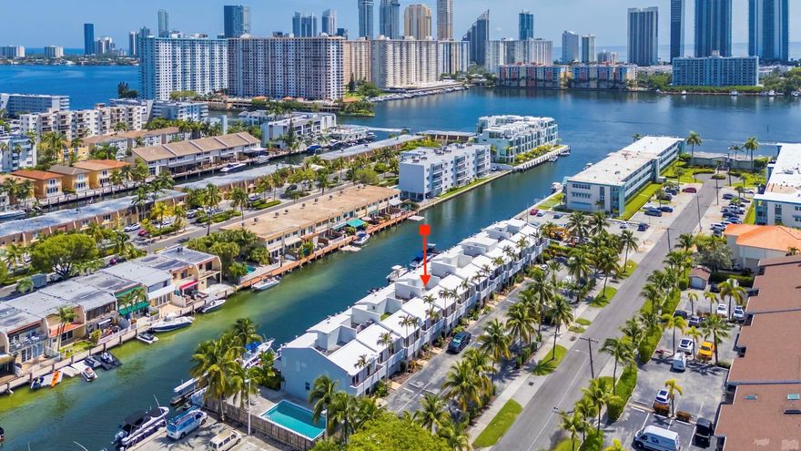 Waterfront townhome with 30-FOOT DOCK. This 3-bedroom, 2.5-bath residence offers direct canal access with a 30-foot dock located immediately behind the home, providing quick access to the ocean via Haulover Inlet with no fixed bridges. The interior features porcelain tile flooring, a recently refinished kitchen with white cabinetry, granite countertops, and stainless steel appliances, and upgraded bathrooms throughout. Additional highlights include IMPACT WINDOWS, two ASSIGNED parking spaces, and a 24-hour guard-gated community in Eastern Shores. Ideally located just minutes from restaurants, grocery stores, shopping, IPIC Theaters, Oleta River State Park, and the beach.