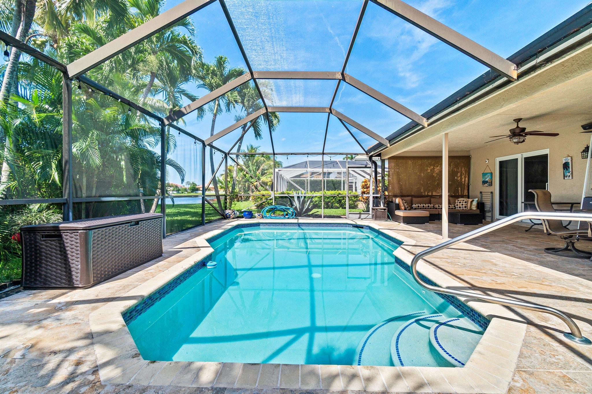 Welcome to this rare corner-lot gem in the highly desirable Le Palais community! Perfectly positioned for privacy and lakefront tranquility, this beautifully renovated 3-bedroom, 2-bath pool home delivers both modern comfort and timeless style.Major upgrades provide peace of mind: concrete tile roof (2019), American Standard HVAC system (2021), Rheem water heater (2018), refreshed pool and dome screen enclosure (2019), and new pool pump (2023). Appliances have been thoughtfully updated between 2019-2024, offering a move-in ready experience.Inside, you'll find a bright, open-concept layout framed by hurricane-impact windows and doors throughout. The chef's kitchen is a true centerpiece with sleek quartz countertops, GE Profile stainless steel appliances, center island, pantry