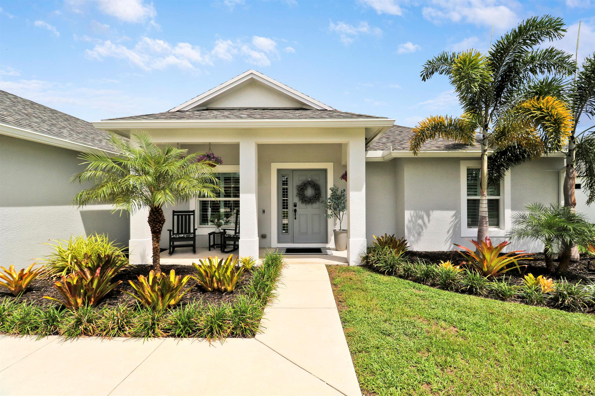 Stunning 3 bedroom, 2 bath smart home with impeccable upgrades and gorgeous outdoor space. This beautifully maintained home is a perfect blend of comfort and style with an open-concept floor plan. Step inside to discover a light-filled interior featuring plantation shutters, impact windows, and tiled flooring that flows seamlessly from room to room. The kitchen boasts stainless-steel appliances and granite countertops. The split-bedroom floor plan offers privacy with a spacious primary suite that includes a walk in closet. 2 additional bedrooms are generously sized & perfect for family, guests, or an office. Enjoy year-round outdoor living in the large, fully fenced backyard, offering plenty of space for kids, pets, or even a pool. This home is truly TURN KEY and waiting for you!!!