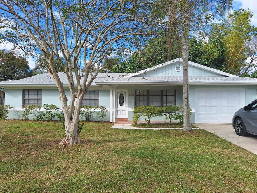 Your private, Florida sanctuary awaits you! This 3/2/1 offers features not usually found in this price range. Backyard offers a fully screened patio with a heated cocktail pool! Great for relaxing living the Florida lifestyle.  Beautiful outdoor shower with hot and cold running water. Giant Banyan tree in the yard priceless! Home feels much larger than actual square footage. This is a must, see! This home is close to shopping, restaurants and less than 15 minutes to the beautiful beaches! Kitchen window pass thru, with  counter top to patio is perfect for entertaining. All new interior door knobs and garage opener with remote. NEW kitchen appliances. NEW ROOF in 2024 Call ''Jonna Convery'' for your private showing today!!