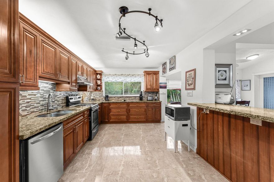 This unit is a must see!! Beautiful, unique corner unit in the town home (villa) section of Poinciana * This home is like no other!! The gorgeous kitchen has been completely updated & opened up: NO WALL for unobstructed views! * This unit has also seamlessly converted the rear porch to living area with a flush, level floor - giving it better flow, over 100 sq ft of extra living area & no awkward step downs like other identical units! * Elegant, huge marble tile floors * Both bathrooms are attractively updated * All impact windows & doors for safety & peace of mind! * 1-car garage * Front screened entry porch & foyer * Enjoy grilling on the back patio with huge, private backyard * 2 pets allowed * HOA includes building insurance, exterior maintenance, roof, lawn care, cable, internet *