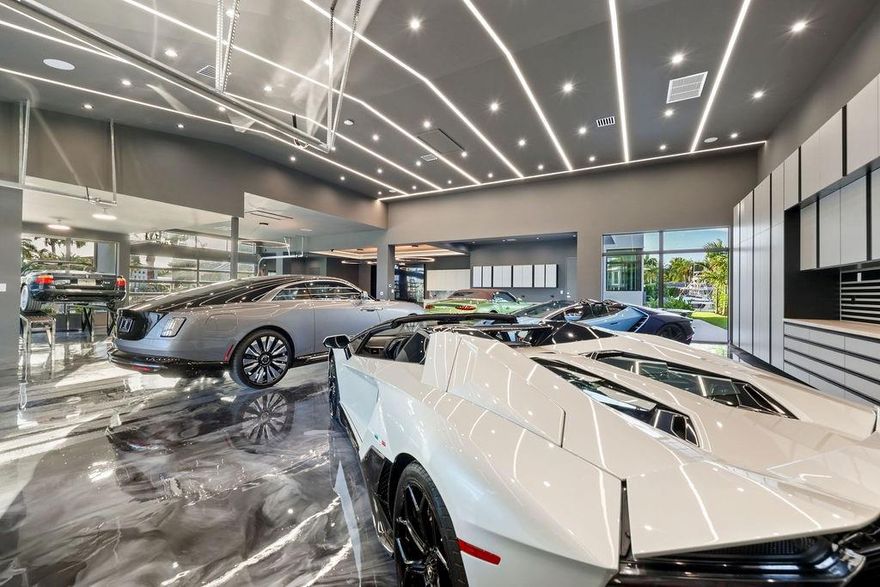 New waterfront estate spanning nearly 13,000 sq. ft. Designed for the ultimate lifestyle, it offers a 3,500 sq. ft. A/C showroom garage with space for 20 cars, a state-of-the-art gym, movie theater, and even space for a pickleball court. With 6 bedrooms and 6.2 baths, the residence features a lavish primary suite, gourmet chef’s kitchen, and a media & club room with a pub-style wet bar. High-volume ceilings, sleek modern design, and floor-to-ceiling windows showcase stunning lagoon views throughout. Outdoor living is redefined with a resort-style pool, summer kitchen, and tranquil water features. A deep-water concrete dock accommodates large yachts, all just minutes from the ocean, beaches, and airport.