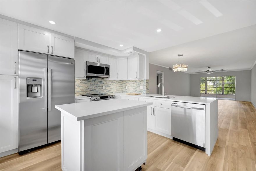 "Move In Ready" Elegant and spacious 2bed 2bath condo with attention to detail and finishes remodeled by an owner/contractor. Upon entrance, you are warmly greeted by a bright and open floor plan with meticulous attention to detail as presented in the kitchen with a lovely new quartz countertop and waterfall, customized glass mosaic backsplash, Under Counter lighting and a rolling island for entertaining. Brand new upgraded stainless appliances with a counter depth refrigerator. The kitchen leads to the large living and dining room with decorative crown molding and baseboard. Luxury waterproof vinyl flooring throughout is warm and easy to maintain. designer bathrooms fully remodeled, Decorative ceiling fans,  New W/H and Electric Panel, Garden views ASSOC REQUIRES 20% DOWN & 1 OCCUP 55+ VACANT/CLICK ON SHOWING ASSIST