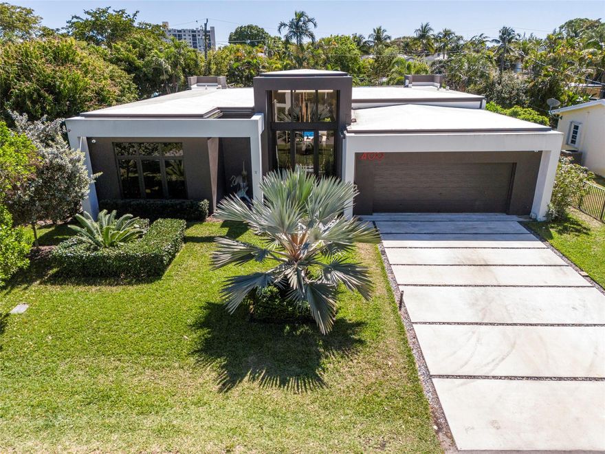 The most exquisite & finest Florida living just steps to vibrant Wilton Drive! Extraordinary, 2022 custom build smart home, w/no detail overlooked. Sleek, Modern, Architectural masterpiece w/impressive curb appeal & dramatic entry w/high ceilings throughout. Designer kitchen appointed w/Miele Appliances, custom cabinetry, libation station & more. Solar panels w/battery back up, 2 EV chargers, buried 500 gal LP gas tank, automated lighting, micro LED ceiling & LED tray & toe kick. Central vac system w/hidden hose & automatic dustpan. Spectacular fenced outdoor space w/covered patio, Pergola w/built-in gas BBQ & kitchen features and a custom Van Kirk salt water pool w/fire bowls w/integrated water feature, max depth 5'. Laminar water jets & bubbler. Many more features too many to list here!