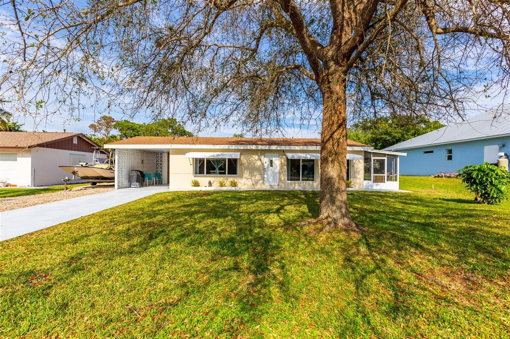 All NEW IMPACT WINDOWS! NEW tile flooring! NEW ROOF 2014! NEW exterior doors! MOVE IN READY! Concrete block home in Poinciana Gardens w/carport and fully fenced yard. 3rd bdrm could be used as den or office. Includes all appliances even washer and dryer. Spacious Dining and Living Room combination. Bedrooms will accommodate king sized beds. Well and septic. Covered patio area, shed and large backyard.