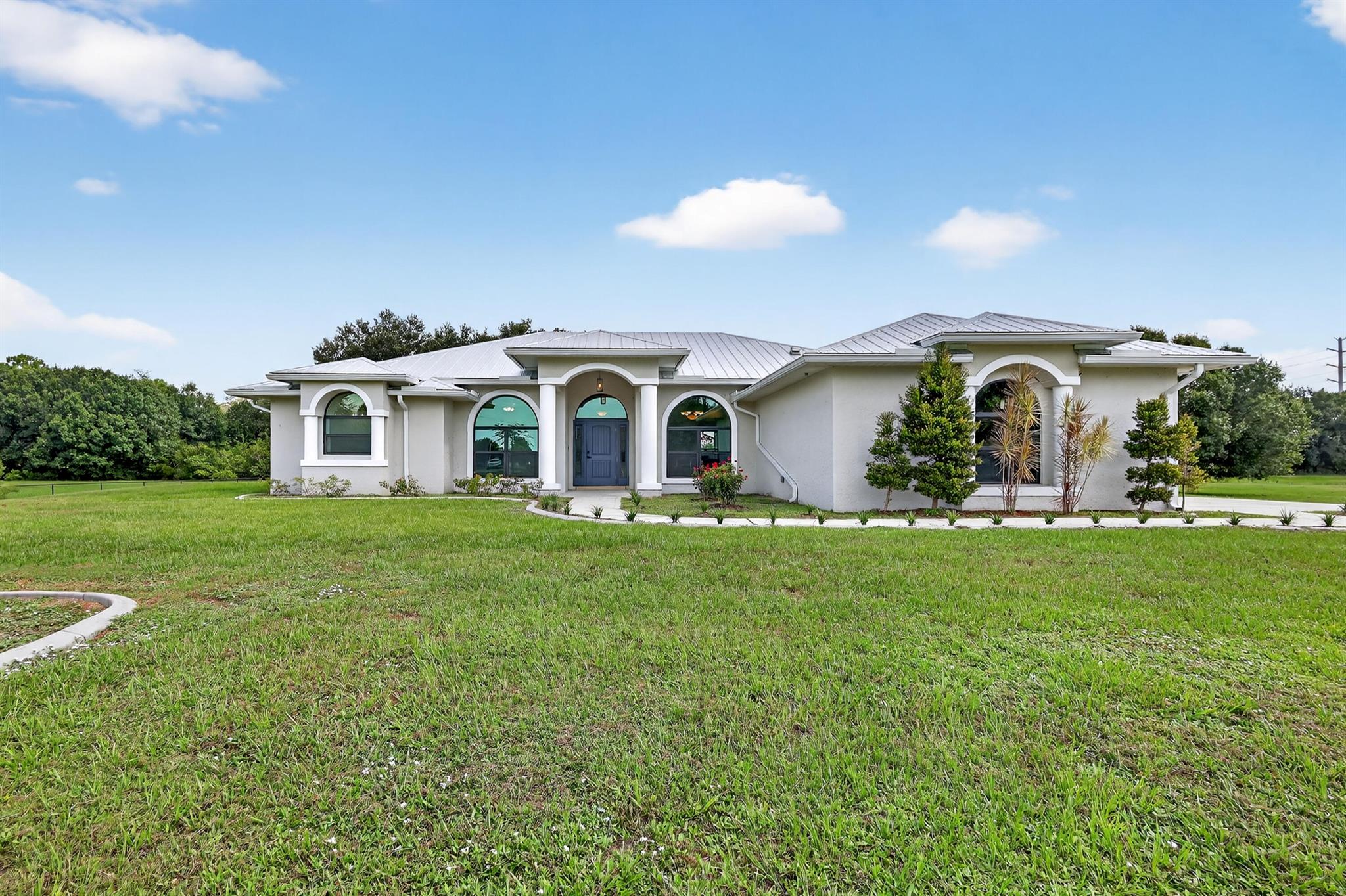 BUILT IN 1999, SITTING ON A CUL-DE-SAC 3.36 ACRE LOT W/PRIVATE POND. ENJOY THE PEACE AND TRANQUILITY OF COUNTRY LIFE AS YOU BACK TO PROTECTED WETLANDS AND NEIGHBORS AN ORANGE GROVE. STARTING IN LATE 2021, THE HOME HAS HAD THE FOLLOWING UPDATES: METAL ROOF, IMPACT WINDOWS AND DOORS, KITCHEN CABINETS W/QUARTZ COUNTERTOPS, SS FRENCH DOOR REFRIGERATOR, SS DISHWASHER, 48'' SS PRO STYLE DUAL FUEL RANGE W/DUAL OVENS AND GRIDDLE. 6' WIDE REACH IN PANTRY W/COUNTERTOP. LIVING AREA AND PRIMARY BEDROOM FEATURE ENGINEERED WOOD FLOOR W/CARPET IN GUEST BEDROOMS. ALL NEW 5'' BASEBOARDS/TRIM AND EVERY INTERIOR OUTLET AND SWITCH HAVE BEEN UPDATED. 120# PROPANE TANK FUELS 2022 TANKLESS WATER HEATER, 2022 DRYER AND COOKTOP. HOME IS GENERATOR READY WITH SAFETY BREAKER. 2024 1HP PUMP FOR WELL SYSTEM.