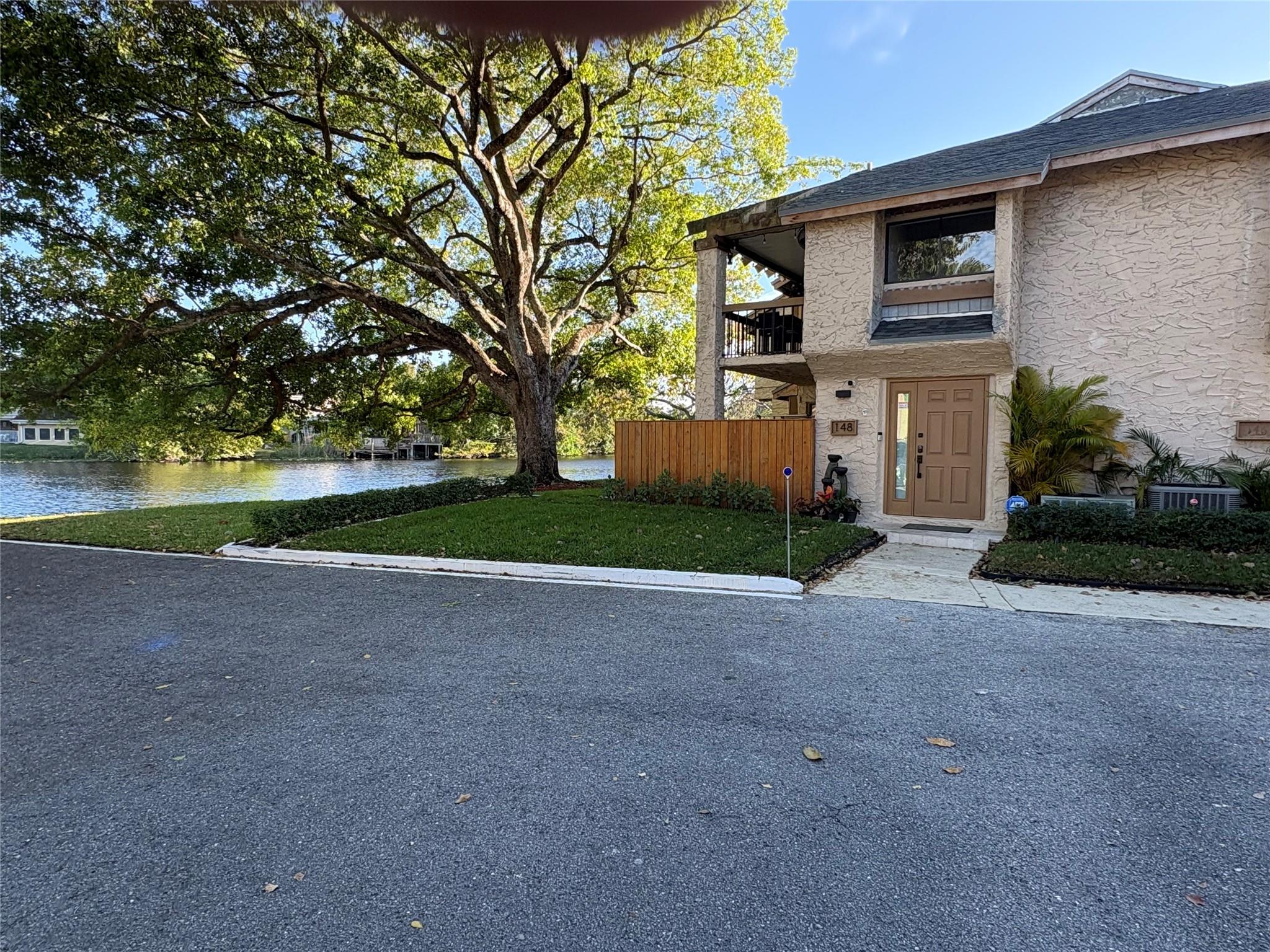 Price reduced to sell! Amazing turnkey, completely renovated 3-bedroom, 2-bath corner condo. The second-floor unit has been tastefully updated throughout including marble flooring, granite countertops and stainless steel appliances. The open layout condo has been carefully renovated with all of the bells and whistles. The condo also includes impact windows, security cameras, top-of-the-line washer/dryer and updated A/C/water heater. The enclosed balcony faces the lake and the condo comes with 2 parking spots. Community amenities include: pool and tennis courts. HOA includes insurance and water. No assessments.