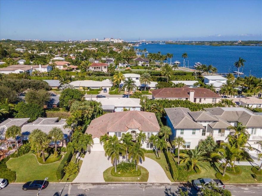 Custom built home on the lake block in the highly desirable SoSo neighborhood.  Beautiful area adjacent to the exceedingly popular walking path of Flagler Drive.  Views of the intracoastal from the balconies of two of the three bedrooms on the second floor.  All five bedrooms have their own private ensuite.  The master is located on the first floor with its grand double door entry, hardwood floors, built-ins, tray ceiling and entrance to veranda and pool.  The master ensuite offers double vanities, Roman tub and separate shower embellished with travertine tile.  This 5 bedroom plus den, 6.5 bath home is bright and airy with vaulted ceilings and a winding staircase leading to the second floor.  Kitchen is open concept with island, quartz countertops and Kitchen Aid SS appliances.