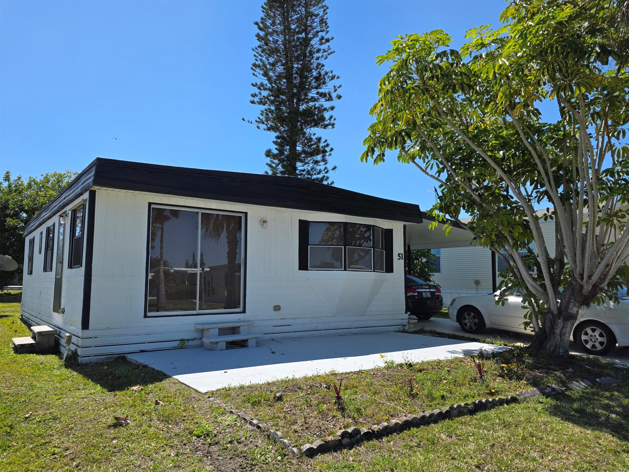 This 2 bed,2 bath is a handyman special and nestled in a quiet 55+ community on the water! Beautiful, spacious yard area with spectacular water views. This home is perfect for a serene retreat or entertaining guests. Located minutes from the beach, this home offers the best of coastal living & convenience;1-2 miles from grocery store, bank, pharmacy, post office & more. Whether you're looking for a peaceful retirement spot or a cozy beach getaway, this home provides comfort, style, in an unbeatable location. Don't miss out! Land lease of 910.60 includes private golf course (no fees to play) pool, fitness, pickleball, tennis, shuffleboard, bocce, gym, library, cards, Mah Jong, bible study, wood workshop, golf cart parades, dinners, dances, trips & more. Lawn cutting & trash included.