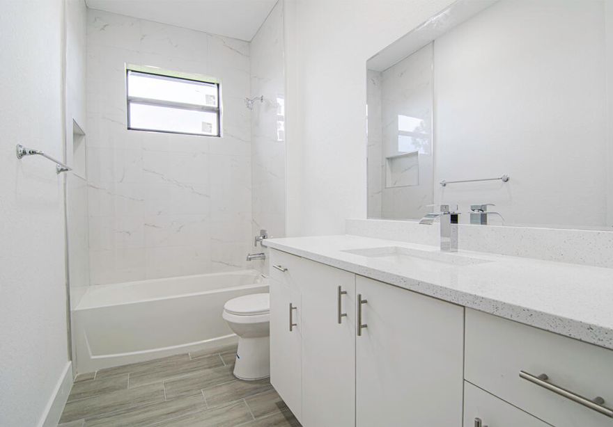 4BR/2BA Single Family Home in Port Charlotte This newly built gem blends modern design and functionality, offering spacious, sun-filled living areas. The kitchen features sleek white countertops, an island, and modern appliances—perfect for any home chef. Enjoy a peaceful, lush yard ideal for relaxation. Located just minutes from Gasparilla Road, this home offers the perfect balance of tranquility and convenience. Virtual staging for illustration purposes.