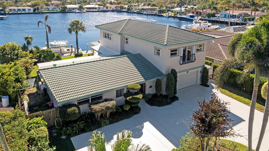 Welcome to wide WATERFRONT views in HARBOR VILAGE, East Pompano. Located on Lake Capri is a 4-bed, 4-full bath home of nearly 3200 sqft, featuring 2 XL master suites and seamless inside to outside living - ready for a new buyer to call this sanctuary home. UPDATED WHOLE HOME ELECTRICAL & PLUMBING. With 80' on deep water, enjoy views from your thoughtfully landscaped backyard, pool, or inside from almost any room. W/ southern exposure, you can enjoy cooler summers & a great breeze. 2 car garage & room to park an RV. Just 5 minutes to Pompano Pier, it's central to everything. Only 2 minutes to the Intracoastal with NO FIXED BRIDGES! Boasting a 24K lb boat lift, head to Hillsboro Inlet for quick ocean access. NO HOA. Quick access to major airports. AC 2019 & 2022. WH 2020. Welcome Home!