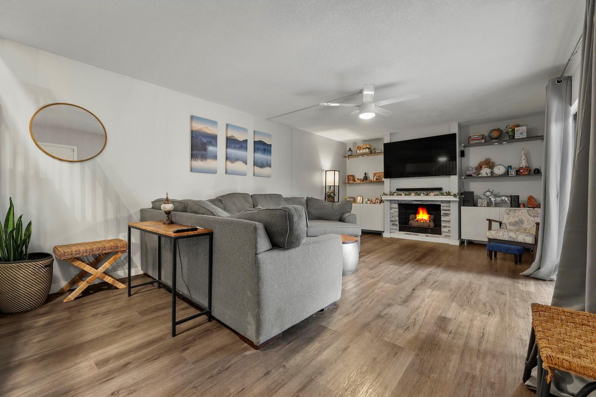 This stunning 2-bedroom, 2.5-bath home has been beautifully renovated in 2021. The cozy living room features a custom built entertainment center and a fireplace, perfect for relaxation. Enjoy the new waterproof laminate flooring throughout, leading to a bright kitchen equipped with quartz countertops and new stainless steel appliances, complemented by a touch less faucet, modern hardware, and elegant light fixtures. The guest bathroom downstairs offers an updated vanity and a stylish barn door that conceals the washer/dryer for added convenience. Upstairs, you'll find a spacious primary bedroom and guest room, both with ample storage. The inviting courtyard features new fencing, astro turf for your furry friends, plenty storage space. As you enter Sandalwood Estates, the majestic trees