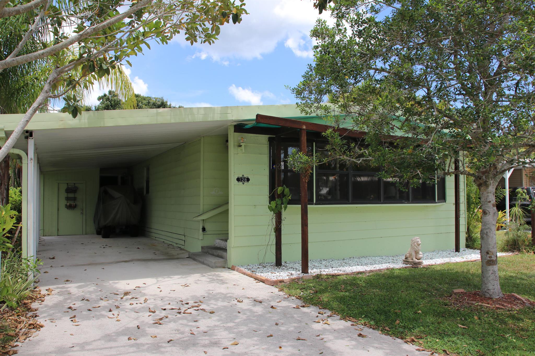 Small Yard, move-in-ready, w/ a Golf Cart, 2 bed/2 bath home! Located on a CulDeSac, Perfect for Privacy, Pets, Gardening & Barbecues!The outdoor green oasis is ideal for daytime relaxing or nighttime star gazing. Outdoor Porch comes w/ Grill & Smoker - great space to entertain/unwind. Large Florida Rm serves as extra living room/den/office! Master bedroom features en-suite bathroom & walk in closet. AC 2023, Metal Roof, Floors Replaced, H20 Heater less 6 mos. Prime location; close to beach, grocery stores, post office, banks, hospitals, pharmacy, mall & more! Lot lease of 977.55 includes lawn care, trash, free private golf course heated pool, pickleball, tennis, shuffleboard, bocce, gym, library, cards, Mahjong, bible study, wood workshop, dinners, parades, dances & more!