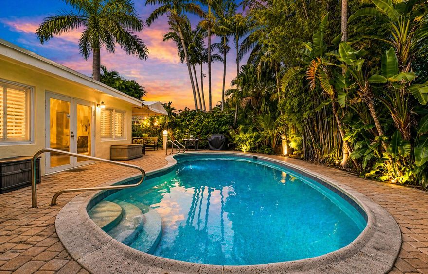 Exceptional 3BR/3BA pool home in Coral Point, Wilton Manors, designed for modern living. With 1,867 sq ft, this residence features two spacious primary suites—with separate access ideal for guests, multigenerational living, or a private home office. Bright interiors include formal living and dining areas plus an oversized family room with plantation shutters, offering comfort and functionality for everyday living or entertaining. Step outside to a private tropical retreat with a heated pool, custom pergola, and lush landscaping for year-round outdoor enjoyment. Energy-efficient upgrades include a $33,000 paid-off solar system (no lease), impact windows and doors, whole-home generator, and Level 2 EV charger—helping reduce utility and insurance costs.  Circular paver driveway adds curb appeal and convenience. Minutes to Wilton Drive, dining, parks, shopping, and nightlife. Move-in ready and one of the best values for a fully upgraded 3/3 pool home in the area.