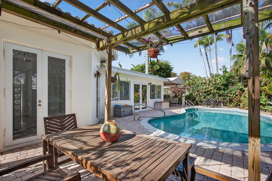 Exceptional 3BR/3BA residence in Coral Point, Wilton Manors, offered furnished and turnkey. Includes a $33,000 paid-off solar panel system (no lease), reducing utility costs. Along with impact windows/doors and a whole-home generator, designed for energy efficiency and insurance savings. The 1,867 sq ft layout includes two primary suites ideal for flexible living, guests, or rental use. Bright interiors flow through formal living and dining areas into a spacious family room with plantation shutters. Outside, enjoy a private resort-style setting with heated pool, custom pergola, and lush tropical landscaping. A paver circular driveway and Level 2 EV charger complete the property. Minutes to Wilton Drive dining, nightlife, and entertainment. Low-overhead, move-in ready luxury living.