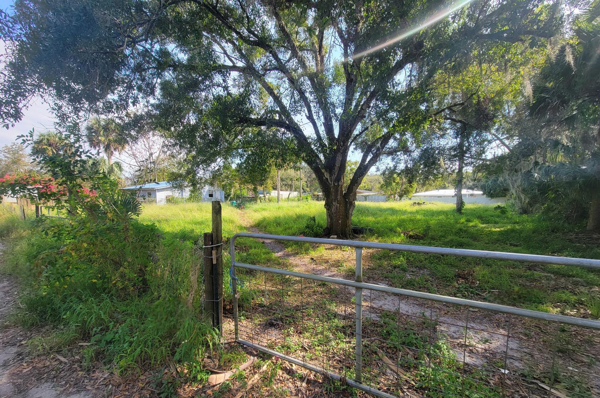 Come check this single-family building lot hidden in the southwest section of Okeechobee. Close to schools, churches, shopping and more but lying just outside the city limits so you won't have to pay the added city taxes. The lot is fenced, cleared and has a huge oak tree for shade. Come take a look.