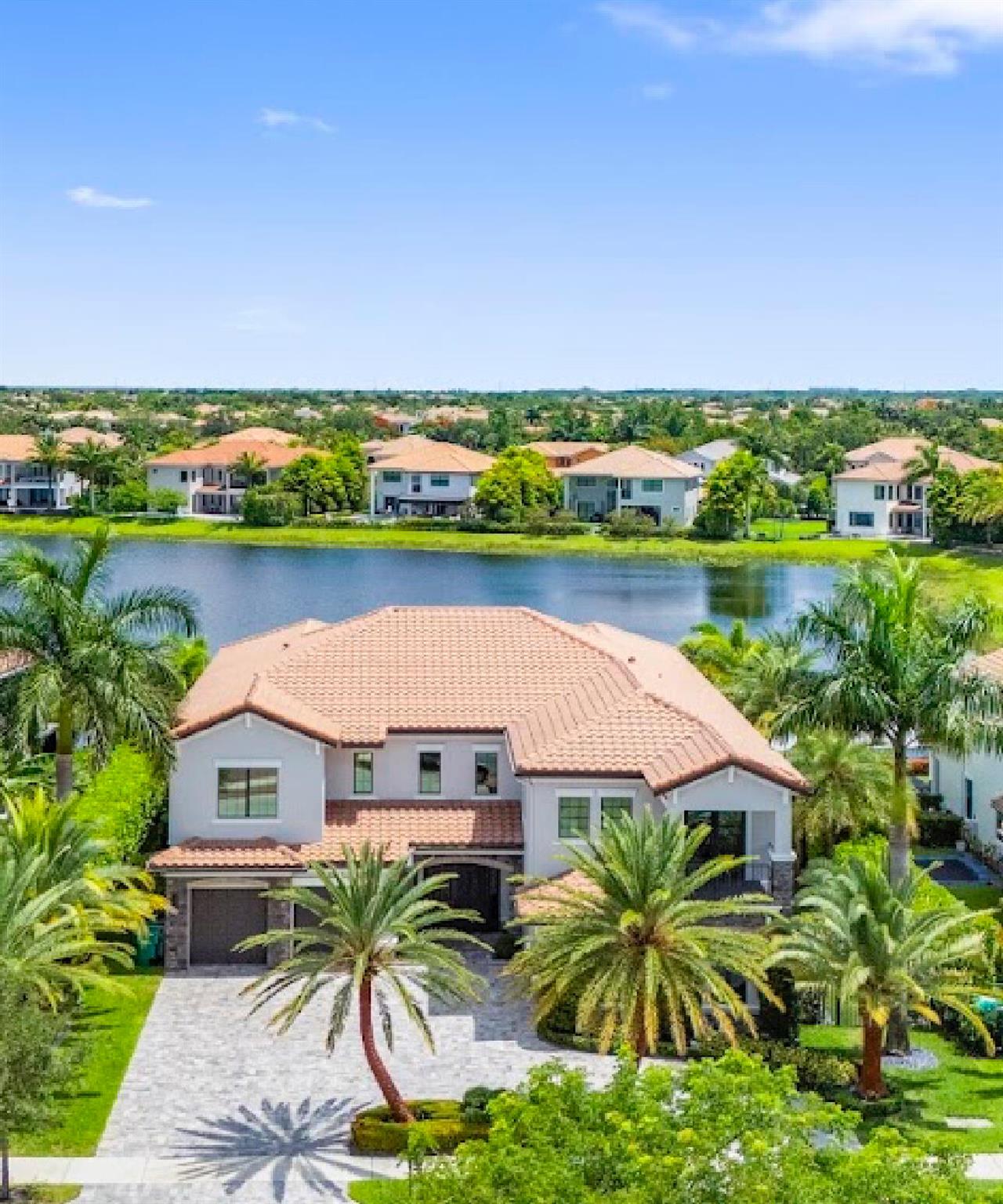 This stunning 5-bed, 6-bath lakefront estate blends modern elegance with resort-style living. Featuring over $875,000 in designer upgrades, including a grand custom dual staircase, fully redone pool with lakeside fireplace, outdoor chef's kitchen, and a private home theater. Floor-to-ceiling windows frame spectacular lake views, while every space is thoughtfully designed with high-end finishes. A rare turnkey masterpiece on the water.