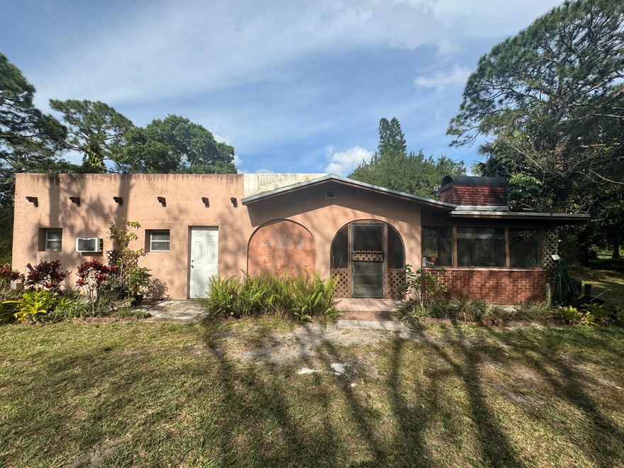 MOSTLY CLEARED HARD TO FIND 5 ACRE LOT IN LOXAHATCHEE GROVE. THIS PROPERTY BACKS UP TO A CANAL AND ALSO HAS A POND WHICH YOU CAN USE FOR CREATIVE IDEAS.  THIS IS A CHANCE TO CREATE YOUR OWN PRIVATE PARADISE. THIS PROPERTY HAS A BARN AND STALLS WITH GROOM QUARTERS. ROOM FOR POOL AND AN ARENA. THIS SPANISH STYLE HOUSE HAS COOK ISLAND KITCHEN, PATIO WITH BUILT-IN GRILL AND REINFORCED SUNDECK. CONVERTED AIR CONDITIONED GARAGE CREATING A FLEX SPACE FOR THE FAMILY. CENTRAL VACCUUM. PROPERTY NEEDS SOME TLC AND IS PRICED ACCORDINGLY. ALL MEASUREMENTS ARE APPROXIMATELY.