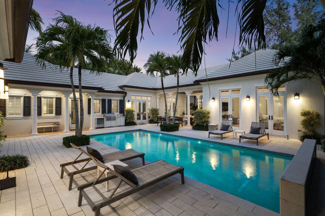 Located in the heart of Gulf Stream, 3424 N Ocean Blvd is a meticulously maintained Bermuda-style estate offering private beach access just steps away. This architectural gem spans 5,875 square feet, featuring a 4-bedroom, 4.5-bath main residence and a separate guest house with an additional bedroom and bath. Designed for effortless luxury, the home showcases vaulted tongue-and-groove wood ceilings, impact windows and doors, marble and hardwood flooring, and custom moldings. The gourmet kitchen, outfitted with top-tier appliances and a spacious island, flows seamlessly into the sunlit gathering room.