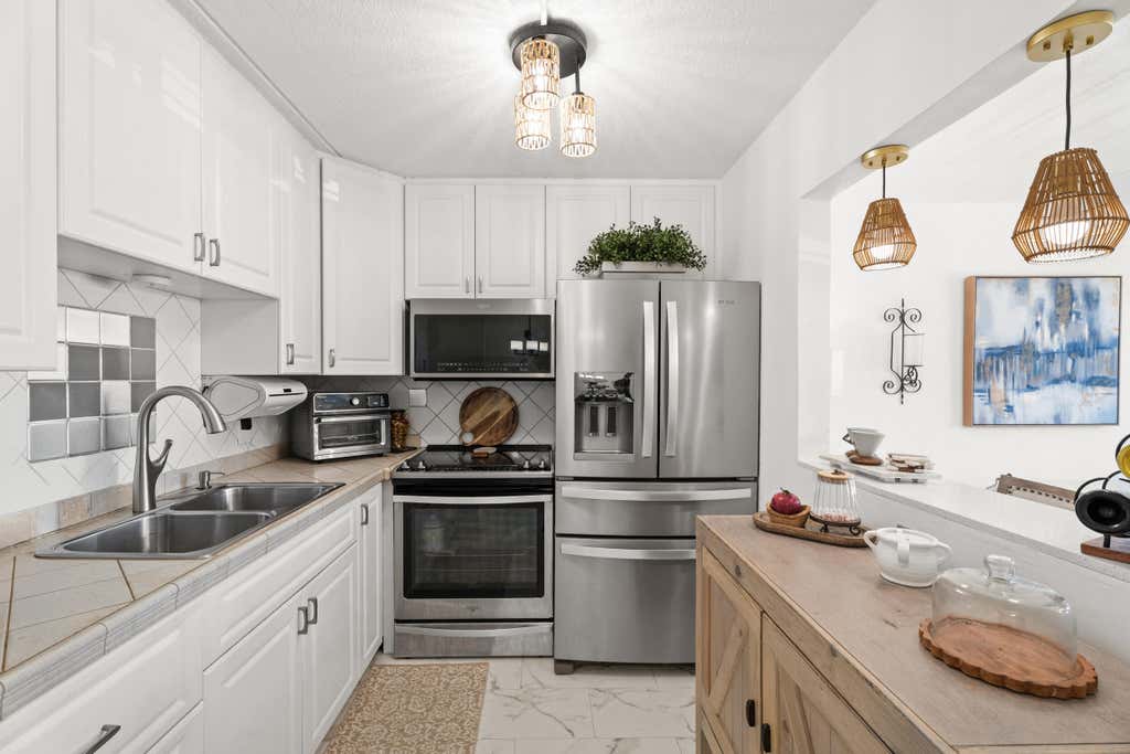 Photo of 200 Village Green Circle E #206, Palm Springs, FL 33461 (MLS # B26044917)
