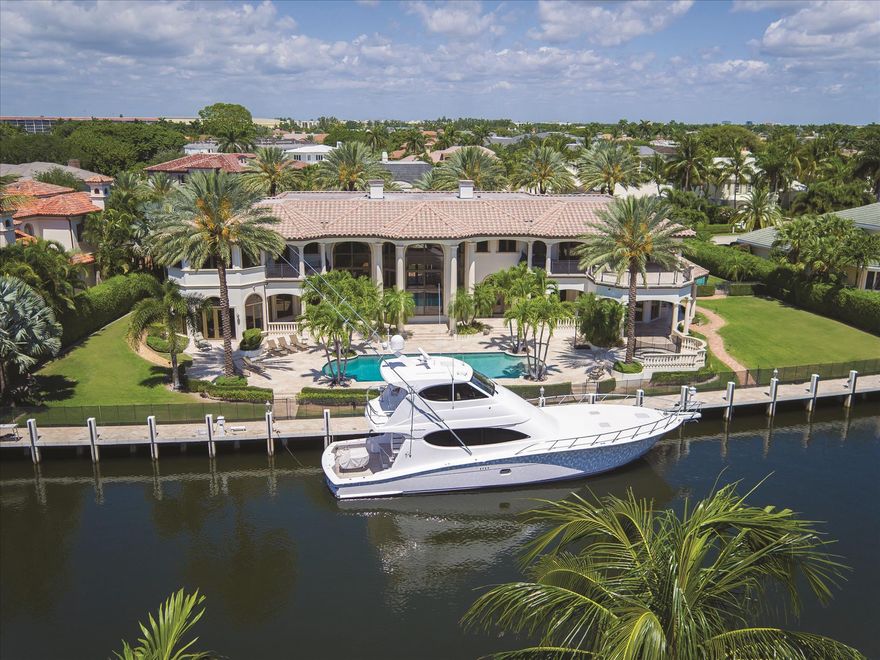 RARE INVESTMENT OPPORTUNITYResiding in Royal Palm Yacht & Country Club on two prime buildable deepwater lots with land value approaching $8 Million, this gated compound sprawls across 216+/- feet outfitted for  multi-yacht dockage - offering a rare value.  Exotic Medjool date palms line the stately Chicago brick motor court that circles around a tiered fountain at the formal entry, continuing to the discreet four-bay garage and guest parking area.  The entire water side of the residence opens to the spectacular tiered terrace featuring grand loggias with a summer kitchen by the immense pool and separate spa.  Lush lawns expand the outdoor entertainment space to either side.