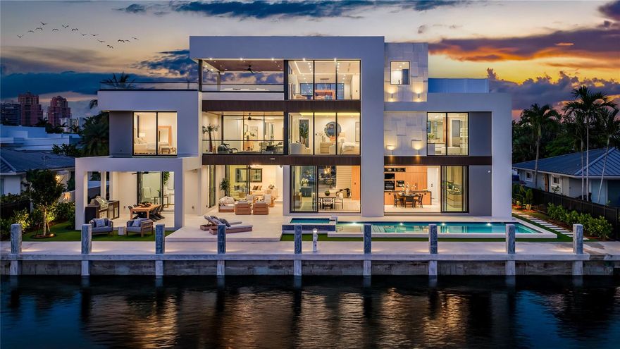 New, Ultra-Modern Gated Deepwater Estate on 100’ of waterfront in Coral Ridge Estates, designed by architect Bruce Celenski, developed by Feldman Development and built by Garza Contractors. This stunning new construction spans 8,286+/- total square feet, featuring five bedrooms, seven full baths, and one half-bath. Highlights include a private office, custom movie theater room, gourmet chef’s kitchen with premium appliances, elevator, and an expansive third-floor club room with panoramic views. Outdoor amenities offer a resort-style pool with spillover spa, a covered pavilion, and a fully outfitted summer kitchen for effortless entertaining. Ideal for boating enthusiasts, the property includes a brand-new full service concrete yacht dock, providing easy ocean access with no fixed bridges.