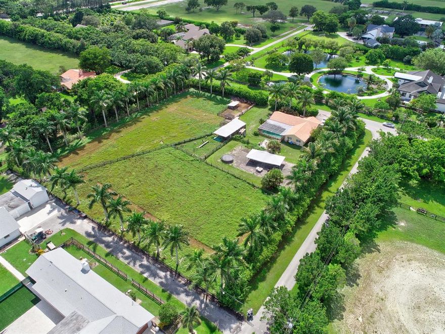 Horseshoe Acre - only available property currently for sale. Build your dream home on this 2.5 acre corner parcel in Horseshoe Acres. This lot is 330x330 in a prime location among multi million dollar estates. Bring Your Own Builder to this Equestrian Community. 41 Multi-Acre Large Estate Homes. Private Riding Trails. Property is lined with mature Palm Trees. Convenient to all major highways, airports, world class shopping, dining, entertainment, the beach and so much more. A rated school system.