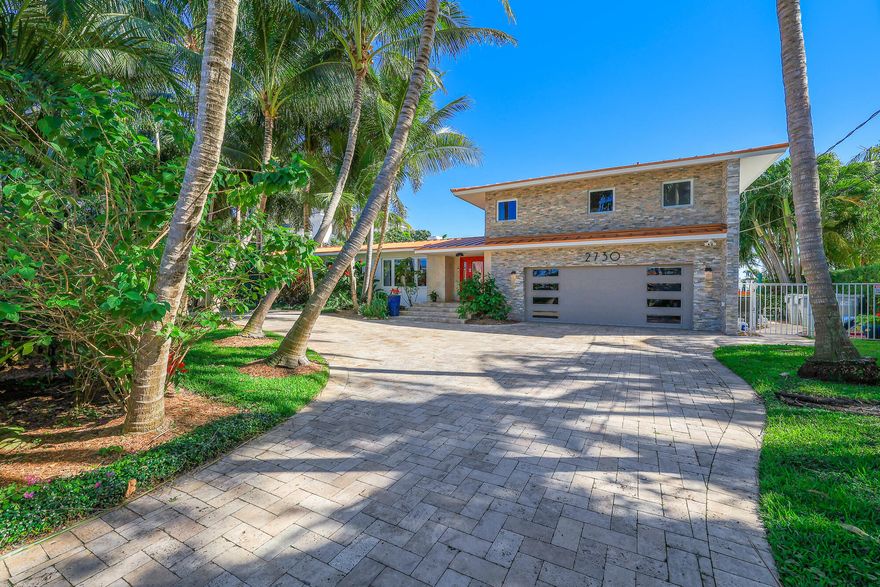 Breathtaking views from this fabulous home that sits directly on Lake Santa Barbara with the most amazing views of the intracoastal as well.  Completely updated with beautiful chef's kitchen and gas cooktop. All Thermador appliances. Porcelain floors in the Master Bedroom. Includes Central Vacuum. Impact windows throughout. Filtered water system throughout the house. The outside offers a luxurious salt water pool with views of the Lake and Intracoastal. Finger dock perpendicular to the seawall, along with Dolphin Pilings grandfather in.  Seawall only 4 years old.  Views of the water from all over. Must see.