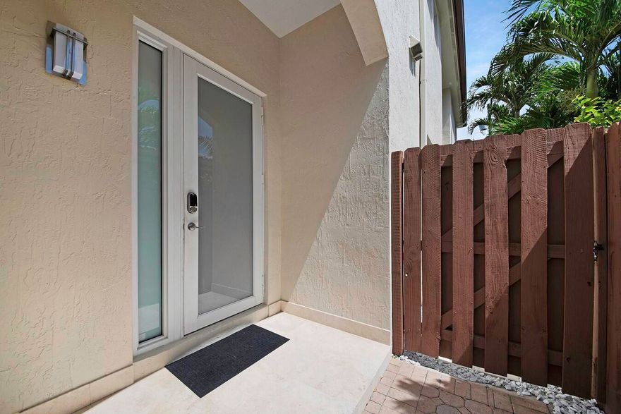 This magnificent townhome features a spacious open floor-plan for today's busy lifestyles. The gourmet kitchen is a chef's dream with granite countertops, full granite backsplash, stainless steel appliances, pantry and a snack bar. The luxurious master suite boasts a French door to the private balcony, custom his and hers walk in closet, dual sinks, soaking tub and a walk in shower. Stunning marble flooring, crown molding, hat lighting and an abundance of natural light are just a few of this homes high lights. Enjoy your tropical paradise on the back patio with a fully fenced yard. Located close to shopping dining entertainment, major highways, airports and the beach.