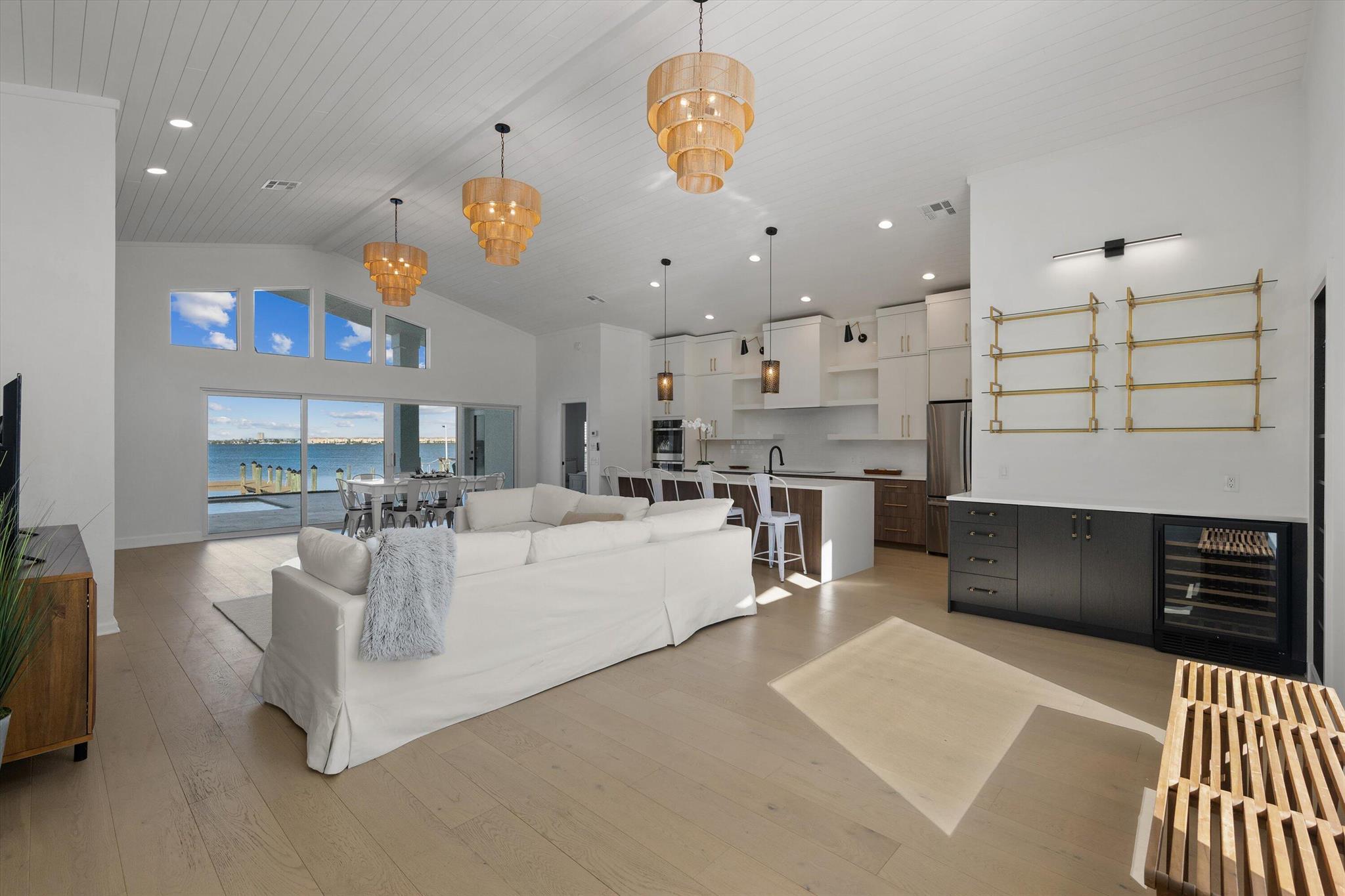 Impeccable newly renovated concrete block home with spectacular panoramic Intracoastal views of the blue water just steps away from the beautiful beaches! Everything is new: new metal roof, new impact windows and doors, new pool and deck, new flooring throughout, new kitchen, new bathrooms, new driveway, new outdoor living and pavers; move in ready! Other features include soaring high ceilings, open floorplan concept with great room, expansive gourmet kitchen with high quality coastal contemporary cabinetry, waterfall quartz countertops; beautiful and durable engineered wood flooring and all 3 new luxurious bathrooms. The interior opens up to the oversized covered patio overlooking the new heated salt water pool and the expansive blue water of the widest part of the Intracoastal, just a