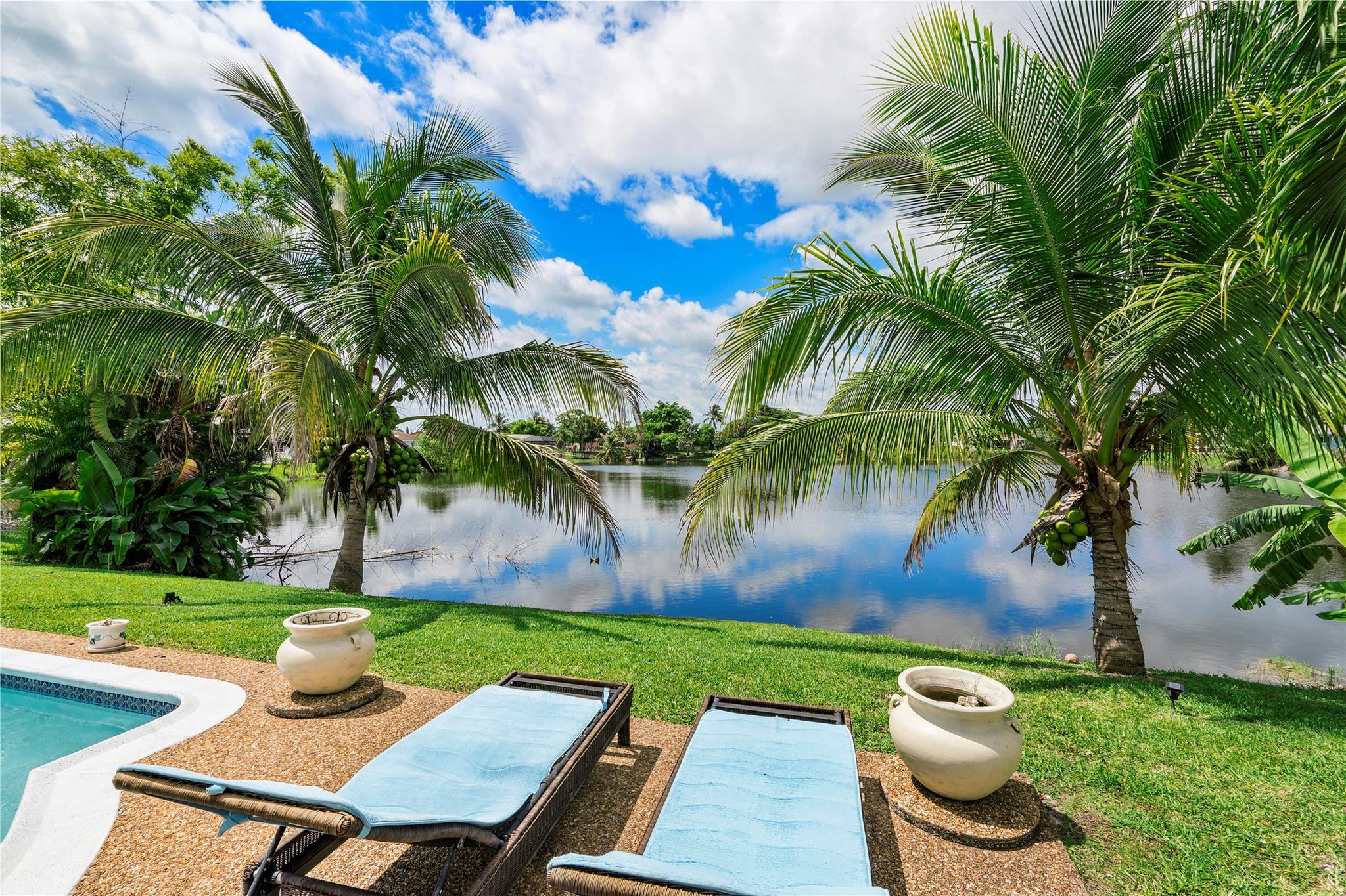 Beautiful **NO HOA** 3 bedroom, 2 bathroom, 1-story single family **POOL HOME** on **WIDE WATER** with garage, private driveway, wonderful **FULLY FENCED-IN YARD** and gorgeous **WIDE WATER VIEWS!!** THIS LOVELY HOME FEATURES A GORGEOUS UPGRADED NATURAL CHERRY WOOD KITCHEN, GRANITE COUNTER TOPS, TILE BACKSPLASH, STAINLESS STEEL APPLIANCES, ROLL-DOWN HURRICANE SHUTTERS, NEUTRAL TILE & WOOD FLOORING THROUGHOUT, FRESHLY PAINTED **INSIDE & OUTSIDE,** RENOVATED BATHROOMS, AND TRANQUIL BACKYARD WITH LARGE COVERED DINING AREA AND PLENTY OF ROOM FOR THE LOUNGE CHAIRS, THE BARBECUE, AND ENTERTAINING!! QUIET STREET AND GREAT NEIGHBORHOOD!