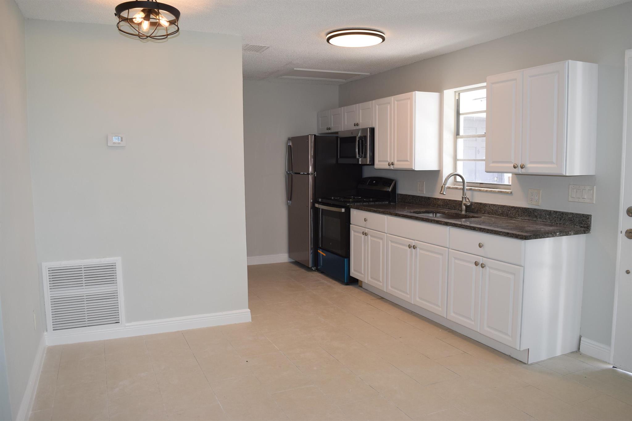 Welcome to this charming 2 bedroom, 1 bathroom home in Stuart, FL. This newly remodeled triplex features a tiled living area and ceiling fans throughout. The oversized driveway provides ample parking space for residents and guests. fully equipped with brand new kitchen appliances and washer & dryer. Enjoy the convenience of living in a triplex, offering a sense of community while still maintaining privacy. Don't miss out on the opportunity to make this cozy house your new home.