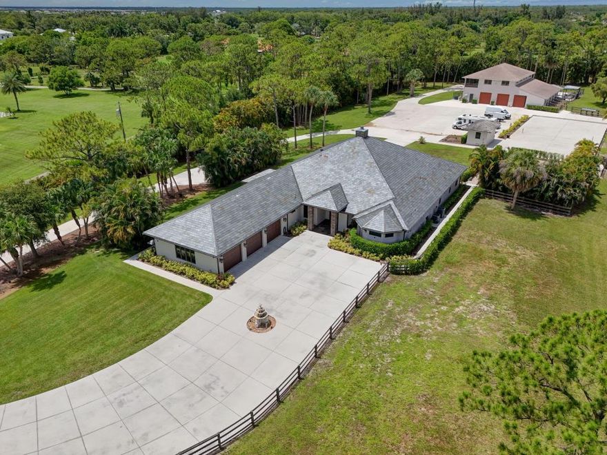 SEE FLOOR PLAN IN DOCUMENTS

Exceptional 10-Acre Estate with Two Residences.  Your privacy begins with the gated entrance to the property framed by two stone columns opening to 10 acres of beautifully manicured open land.  

 The main house, built in 2011, offers 4904 SF of living space.  Upon entering you are greeted by a ''pass-thru'' floor to ceiling, stone fireplace that serves both the living room and the family room.  
This large home features 4 bedrooms and 4 1/2 baths as well as a large gathering/game room with bar seating.  The game room is outfitted with a wet bar, wine fridge, sink, making it the ultimate entertainment hub.
  There is also a very large bonus room adjacent to the Primary bedroom that is ideal for a nursery, home office, yoga room, home gym, et Every room is very generous in size including a 20 x 20 formal dining room perfect for hosting large gatherings.  
The kitchen is beautifully finished with 42" wood cabinets, granite countertops and stainless appliances with a huge walk-in pantry offering loads of additional storage space.
  
The primary bedroom suite measures 26'x20' with the above-mentioned bonus room while the primary bathroom offers a spa-like experience boasting a full-sized sauna, a jacuzzi tub, walk-thru shower and his and her water closets.  

Two of the guest bedrooms, also very generous in size, feature their own en-suite bathroom ensuring comfort & privacy.  

A 20 x 40 - 10' deep pool, impact windows , beautiful SLATE roof and spacious three-car garage completes the main residence.  
  ________________________________________
Second Residence & Guest Facilities...ALL CBS CONSTRUCTION 

The guest house, built in 1995, offers an additional 1,800 square feet of comfortable living space on the second level, with 2 bedrooms and 2 full bathrooms. It is accessible via stairs or a private elevator ideal for guests, extended family, or caretakers.

Below the guest quarters, the first level offers exceptional functionality and flexibility with a kennel area for your k-9 friends complete with a wash station, restroom, washer & dryer a huge 25' x 11' storage room with a floor to ceiling roll-up garage door.  
The center of this building is an expansive 59' x 29' garage/workshop with double roll-up garage doors on either side perfect for a car collection, RVs, boats, workshop, or large-scale storage.  

Adjacent to the garage is a concrete block 4-stall barn, with each stall measuring 11' x 11', plus a dedicated tack room. 

The 10 acres of land offers ample space for paddocks, arenas, or additional outbuildings if desired.

This estate blends comfort, craftsmanship, and limitless potential ideal for car enthusiasts, hobbyists, equestrians, multi-generational living, or anyone seeking a self-contained, luxury retreat.  

A golf cart or two included.  :)