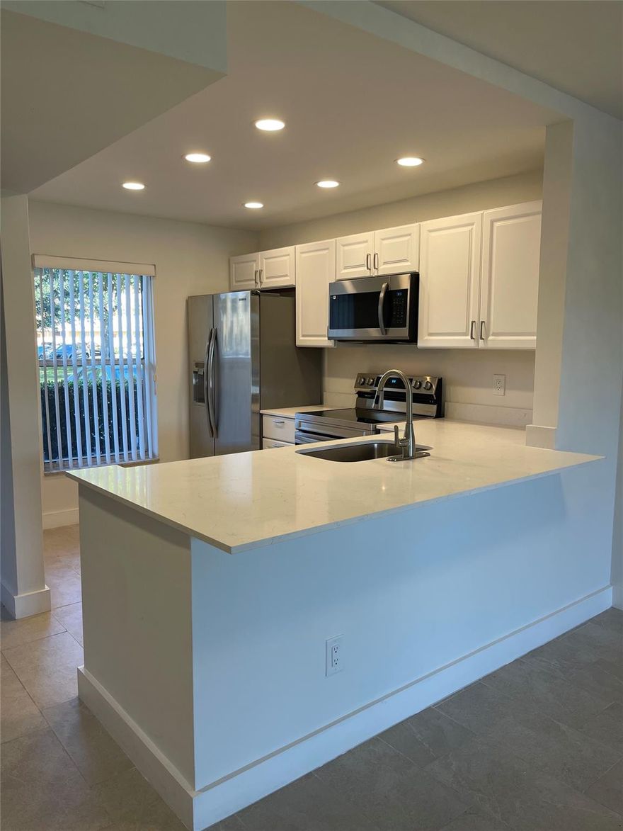 Move right into this beautifully renovated, light and bright 2BR/2BA first-floor condo. Conveniently located right next to parking, it features a beautiful serene lake view, enclosed patio, beautiful white kitchen with brand new stainless steel appliances, walk in closets, and neutral finishes throughout. Freshly painted and move-in ready, this stunning home offers the perfect blend of modern style, comfort, and convenience in prime location. Enjoy the wonderful amenities this community has to offer along with the convenience of its central location. This one wont last....