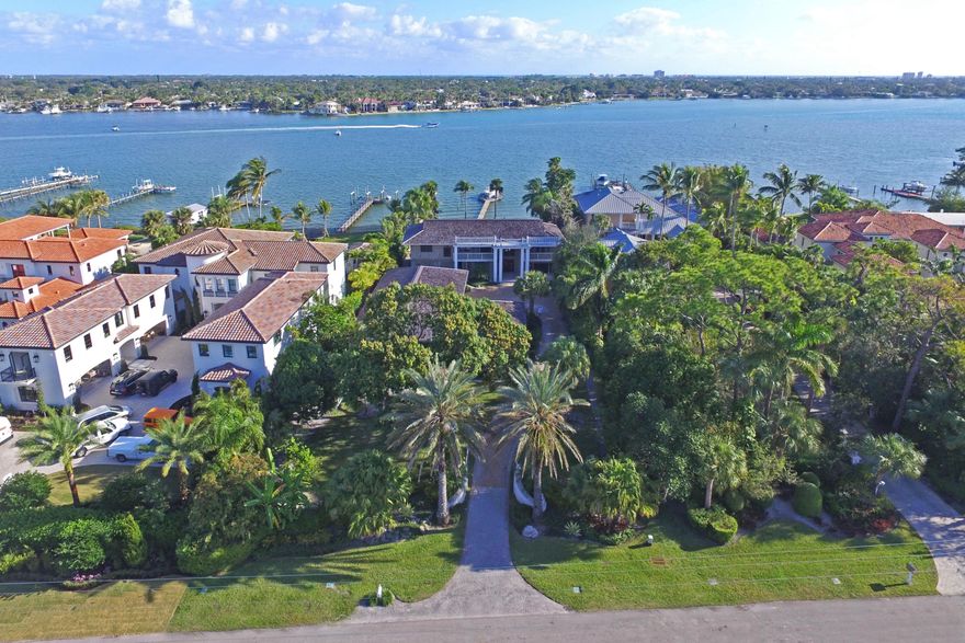 Southern Plantation Riverfront Estate located on prestigious Pennock Point, the most desirable neighborhood on the beautiful, scenic Loxahatchee River.  The 3/4 acre property is located on the widest part of the River and offers amazing water views throughout and has a gated entrance, long winding driveway, mature trees, detached 8+ car garage, private pool and fully equipped dock on the River.  Features of this 5 Bedroom/5 1/2 Bath home (CBS construction on first floor) include formal living & dining rooms, open kitchen with stainless steel appliances, large game room and spacious bedrooms, 3 with sitting areas.  The large covered patio, huge upstairs balcony/deck, black bottom pool, spacious backyard and fully equipped dock, make this the ideal home to entertain in, S. Florida Style!!!