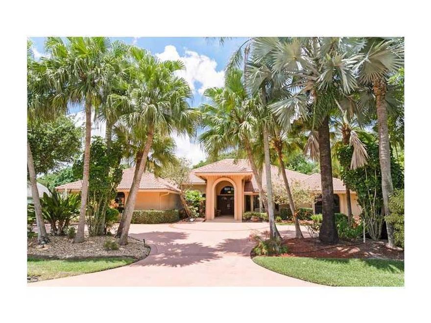 Stunning elevation w/circular drive! Exquisitely remodeled! Hrdwd flrs: LR, DR, bdrms. Amazing chef's kitch: 6-burner gas stove; double ovens; limestone cntr island & flr (& FR flr); CUSTOM wood cabinets; brushed, honed granite counters & backsplash; st.  steel appliances; & butler's pantry! FR:stacked stone wall w/wetbar! Breathtaking MBA!Stunning built-in, oak 4th BR/study! Beautiful pool/patio:built-in grill w/bar; raised, stone spa! Impact drs & windows! Post-Wilma roof! Generator!Walk to park &Chabad!