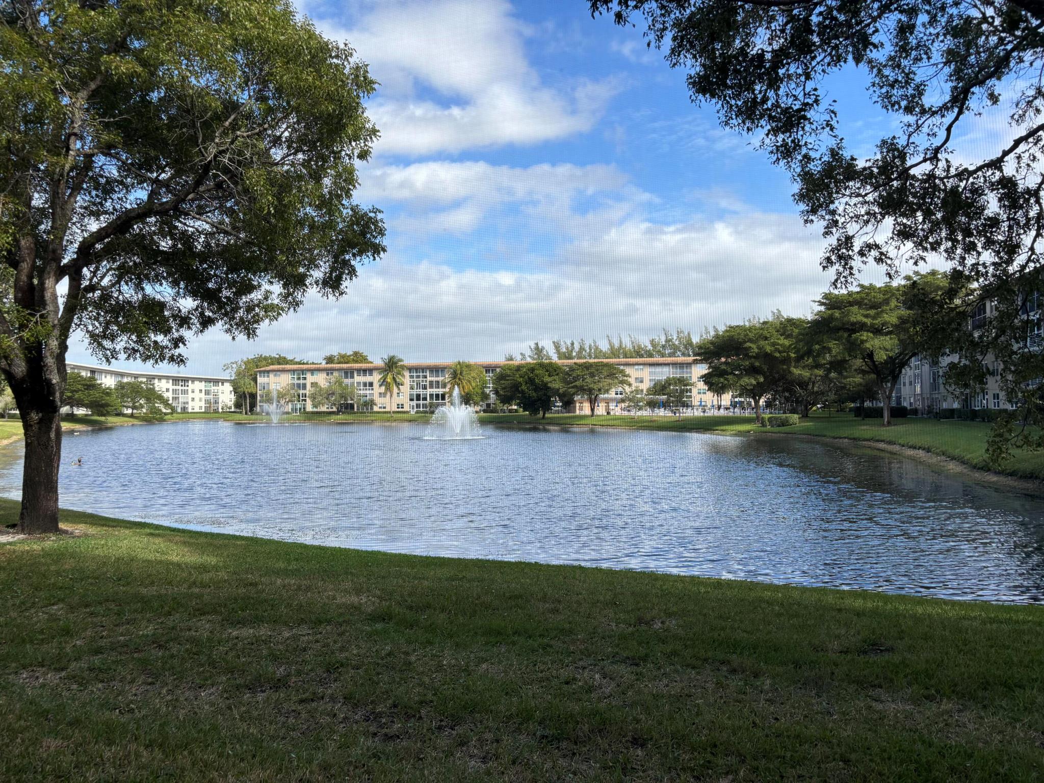 Wow, what a view! This 2-bedroom, 2-bath deluxe ground-floor condo in a gated community features a screened patio with stunning views of the lake, fountain, and pool. Enjoy an eat-in kitchen a washer/dryer in unit, walk-in closet in the primary bedroom, and extra storage. Located in Wynmoor, an active adult community boasting a 50,000 sq. ft. clubhouse, cafA(c), 19 pools, walking pool, Jacuzzi, tennis, pickleball, fitness center, theater, billiards, art classes, over 80 clubs, and an 18-hole golf course. Discover the vibrant lifestyle Wynmoor offer, it's more than a home, it's a lifestyle!