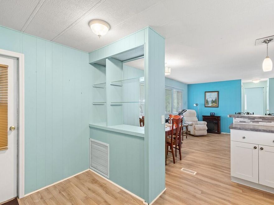 This 2/2 mobile home located in the 55+ community of Pinelake Village in Jensen Beach has a cute beachy vibe that makes for a great getaway or a perfect retirement home.  The kitchen and bathrooms have been totally remodeled and it has a new A/C unit and new washer and dryer, new flooring throughout, and a large screened in patio.   The roof has a lifetime warranty, vapor barriers to keep your crawl space dry are intact and it also has double tie-downs.  Lot rent is only $765 per month and includes cable, trash removal, recycling and all the amenities of the clubhouse.  Conveniently located close to downtown Jensen Beach for shopping, dining, and the beaches.