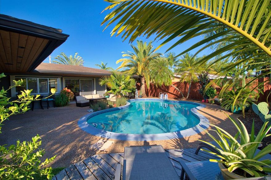 Ready to entertain?  This gorgeous 3 bedroom/3 bathroom pool home in desirable Sunflower in Tamarac is the perfect home for entertaining guests - outdoor living with freeform saltwater pool, luxurious custom accent lighting, and nickel gap ceilings on the patio.  Pass-thru window in the kitchen for indoor-outdoor life.  This is a modern smart home, complete with a home automation system, patio speakers with built-in Alexa, and electronic locks on all entry doors. Large multipurpose room off kitchen is the 4th legal bedroom - all you have to do is put up the wall!  Updated kitchen with granite and new appliances (2017).  Bathrooms ready for your touch.  Come live and relax in paradise!  Check out the 3D Virtual Tour to walk through the home.