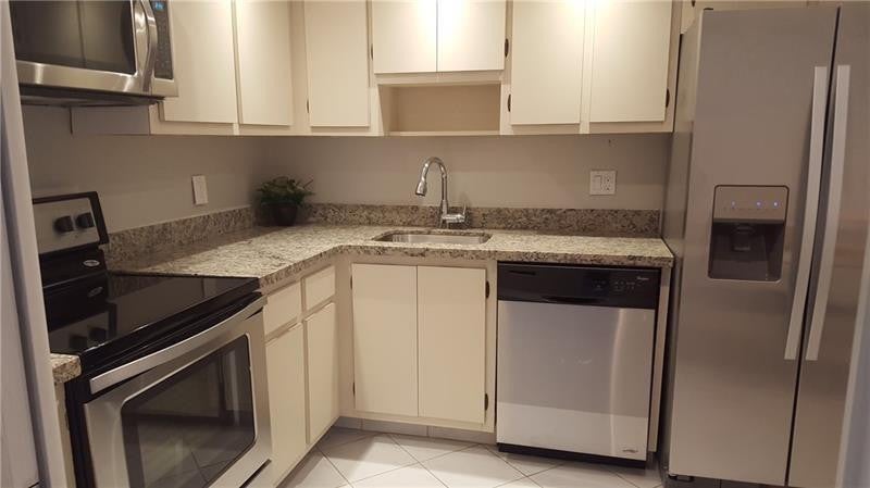 Photo of 3970 OAKS CLUBHOUSE Drive #310, Pompano Beach, FL 33069 (MLS # B26079896)