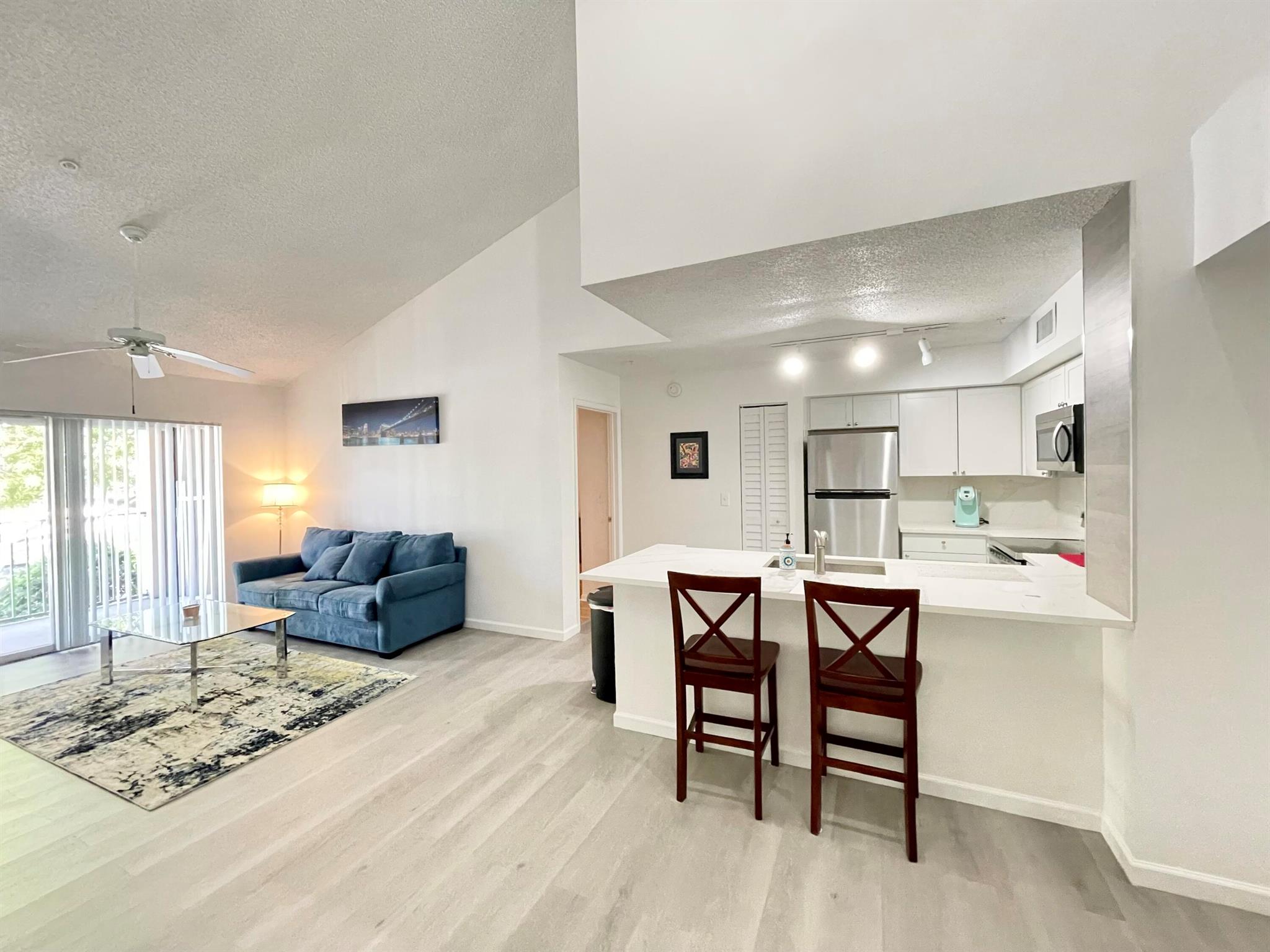 Enjoy just RENOVATED spacious 2 bedroom, 2 bath condo on 2nd floor in desirable gated St. Andrews At Boynton Beach. Basic CABLE TV & WATER, sewer, trash included in rent. BRAND NEW KITCHEN with white shaker cabinets, Calacatta quartz countertop & backsplash, stainless steel appliances. NEW vinyl floor in living area and laminate in bedrooms. HIGH VAULTED CEILING...Split floor plan with open living room with a balcony. Full size washer & dryer. Resort style community with heated pool, jacuzzi, fitness room, clubhouse. Desirable A-rated schools! Your new home awaits.